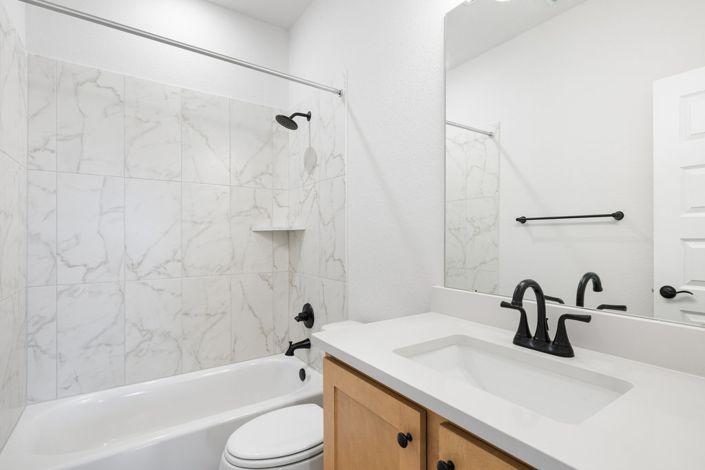 6313 Leftwich Cove Austin, TX 78738 - Photo 28 of 39 a bathroom with a sink toilet and shower