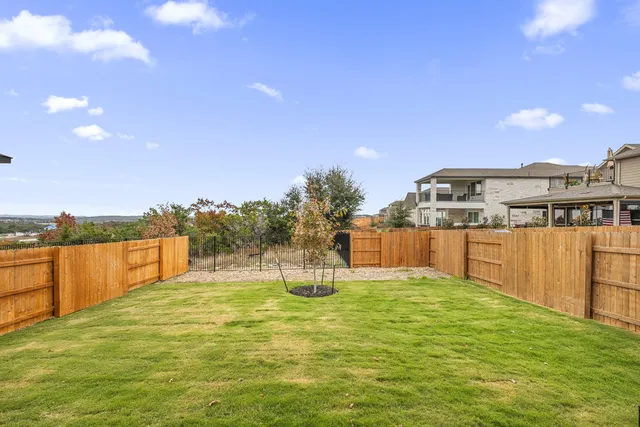 a swimming pool with an outdoor seating and a garden