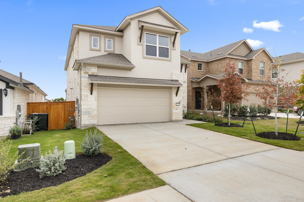 6313 Leftwich Cove Austin, TX 78738 - Photo 36 of 39 a front view of a house with a yard and garage