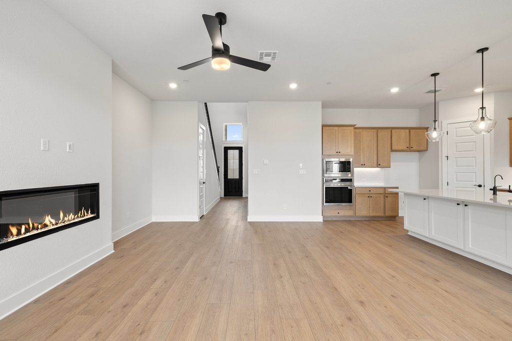 6313 Leftwich Cove Austin, TX 78738 - Photo 5 of 39 a view of kitchen with refrigerator stove microwave and cabinets