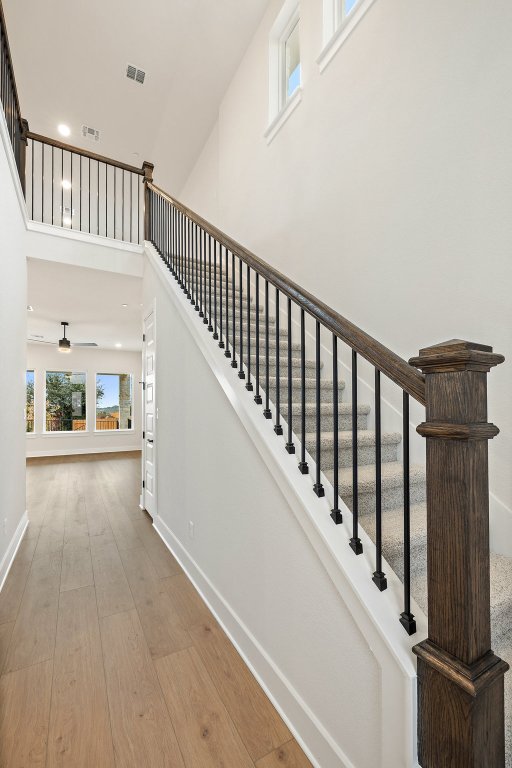 6313 Leftwich Cove Austin, TX 78738 - Photo 9 of 39 a view of staircase with lots of frames on wall and windows
