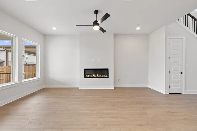 a view of kitchen with kitchen island white cabinets and wooden floor