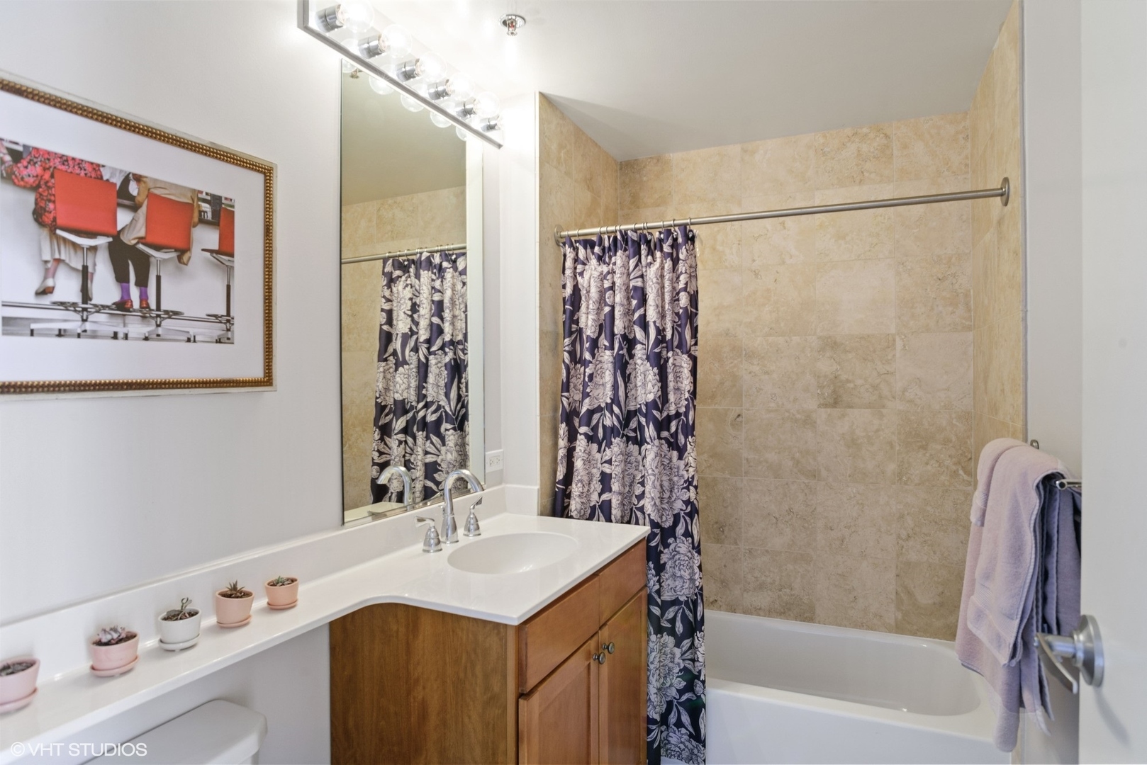 600 West Drummond Place, Unit 511 Chicago, IL 60614 - Photo 15 of 17 a bathroom with a sink a mirror a bathtub and shower