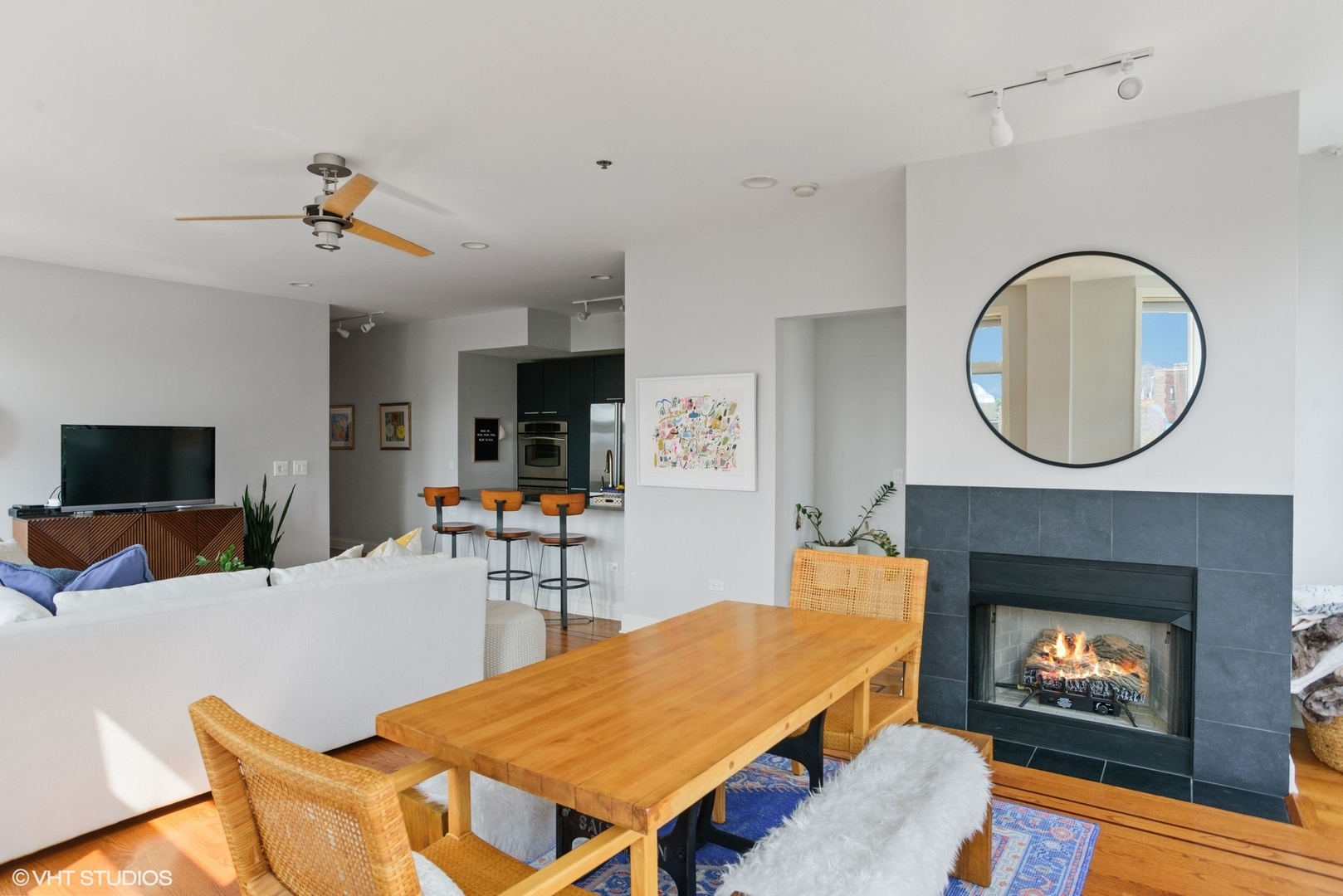 600 West Drummond Place, Unit 511 Chicago, IL 60614 - Photo 8 of 17 a living room with furniture a flat screen tv and a fireplace