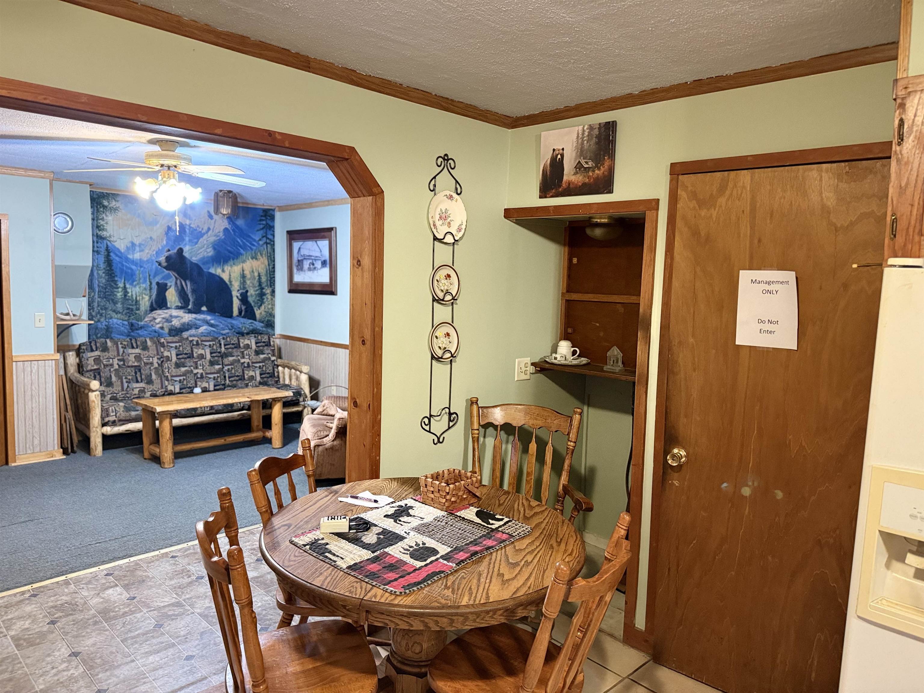 150 West 2nd Street Glidden, WI 54527 - Photo 11 of 32 Dining space with ornamental molding, a textured ceiling, arched walkways, a wainscoted wall, and ceiling fan