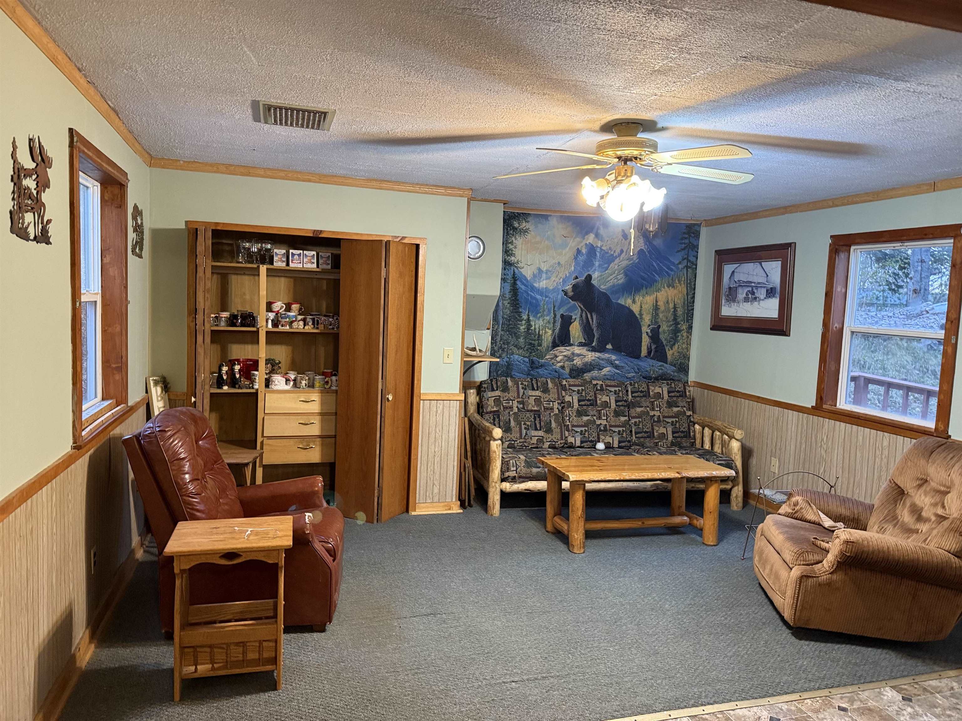 150 West 2nd Street Glidden, WI 54527 - Photo 13 of 32 Carpeted bedroom featuring wainscoting, a textured ceiling, crown molding, wood walls, and a ceiling fan