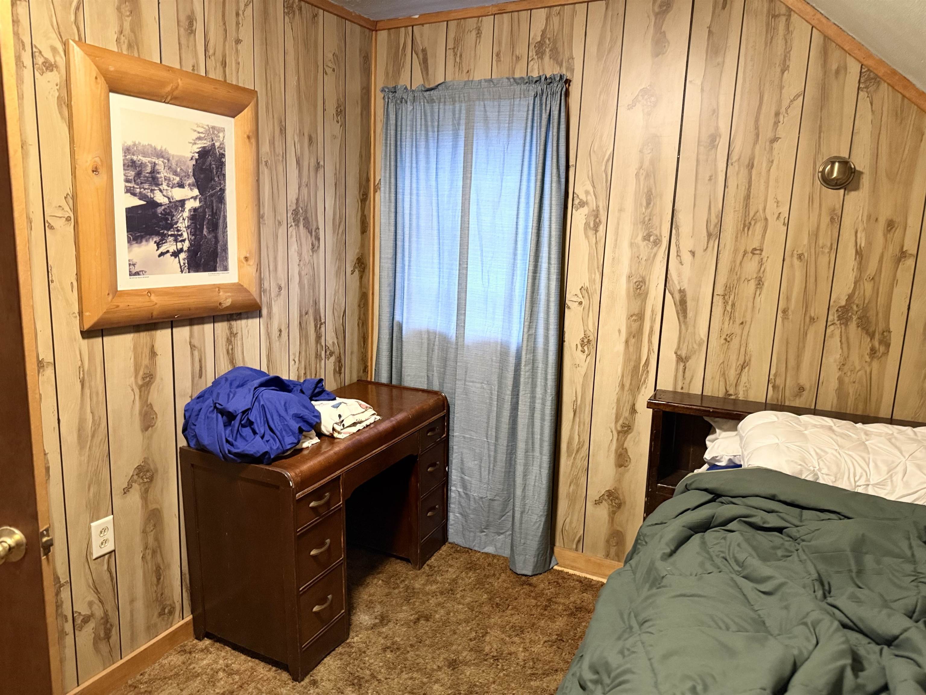 150 West 2nd Street Glidden, WI 54527 - Photo 22 of 32 Bedroom featuring carpet flooring and wood walls