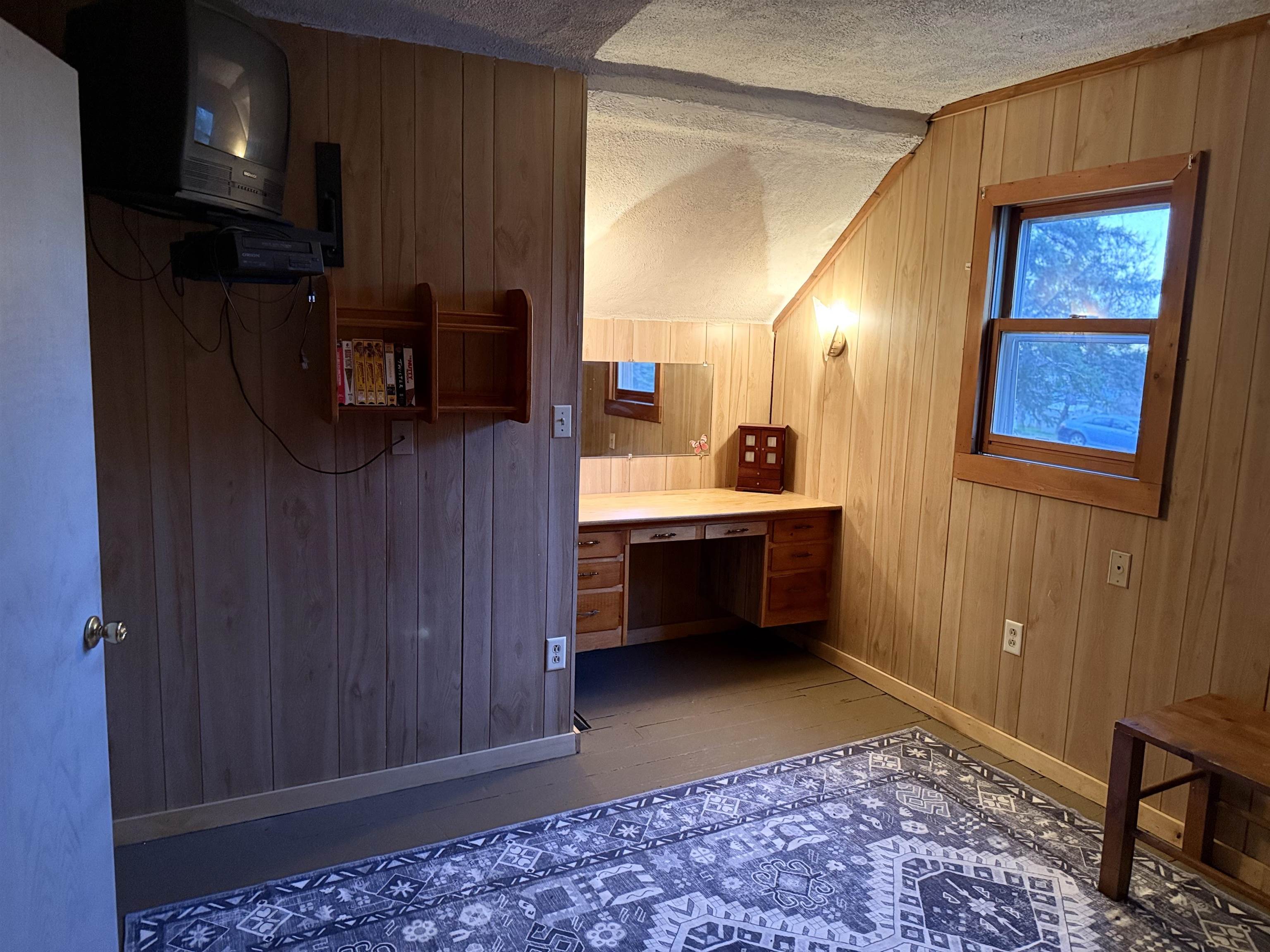 150 West 2nd Street Glidden, WI 54527 - Photo 23 of 32 Bathroom featuring wooden walls, vanity, a textured ceiling, dark wood-type flooring, and vaulted ceiling