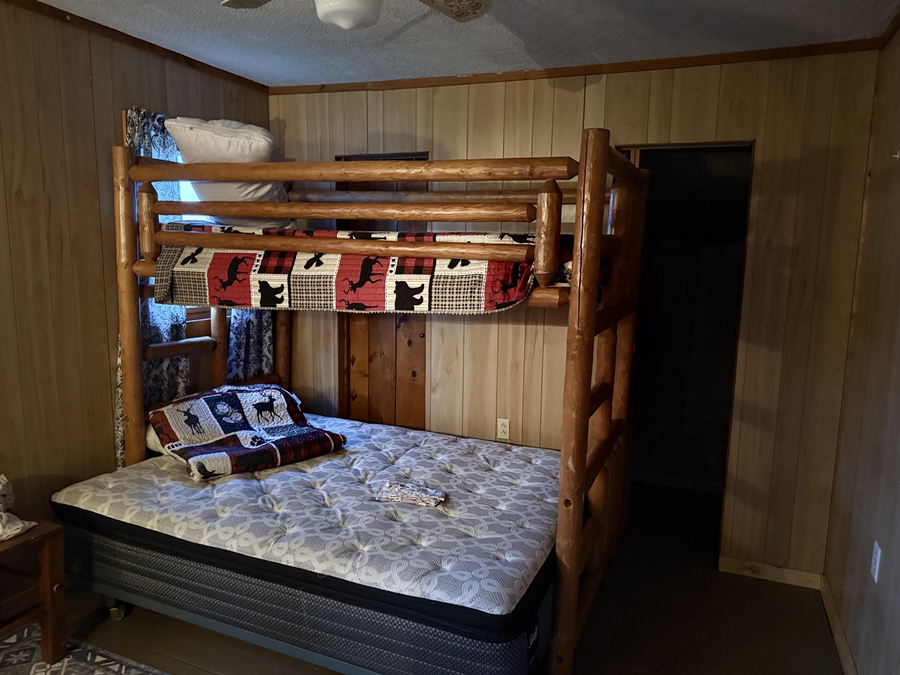 150 West 2nd Street Glidden, WI 54527 - Photo 24 of 32 Bedroom featuring wooden walls, a textured ceiling, and crown molding