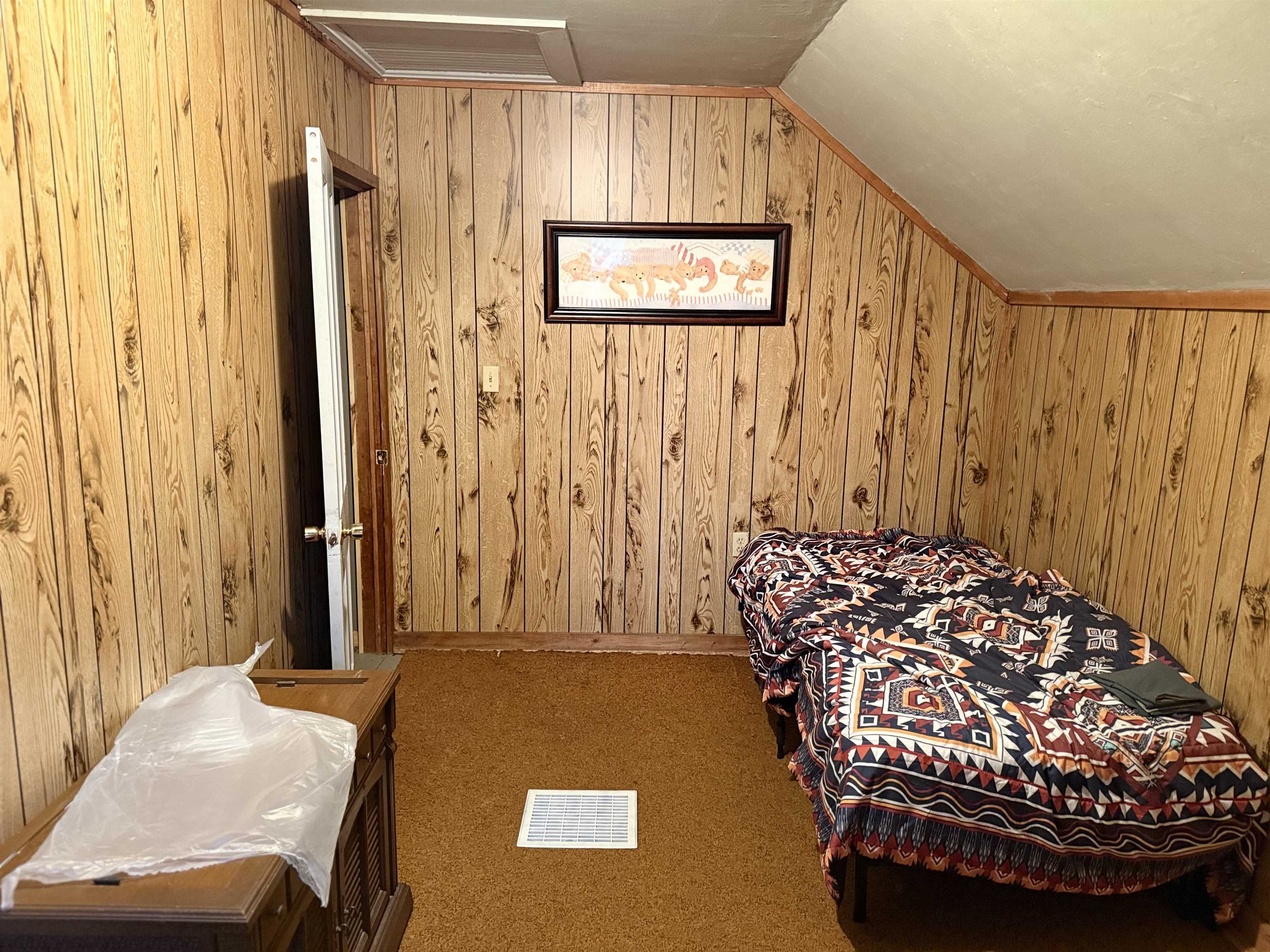 150 West 2nd Street Glidden, WI 54527 - Photo 29 of 32 Bedroom with wood walls, vaulted ceiling, carpet floors, and attic access