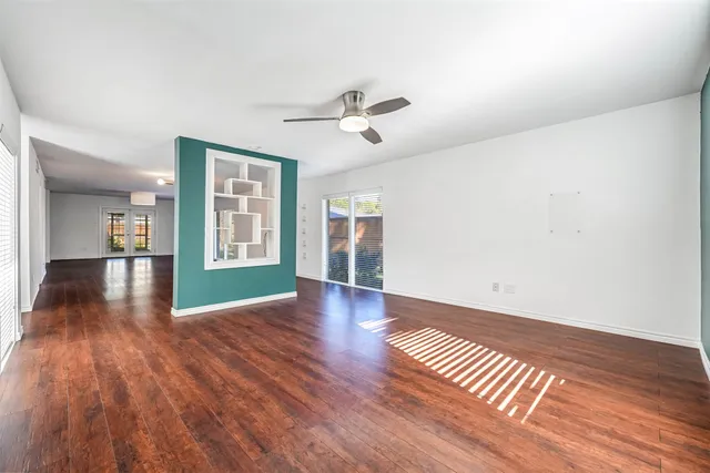 wooden floor in an empty room with a window