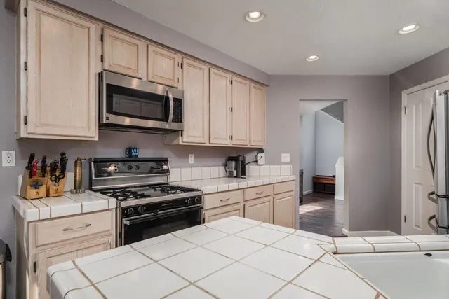 a view of empty room with wooden floor and windows