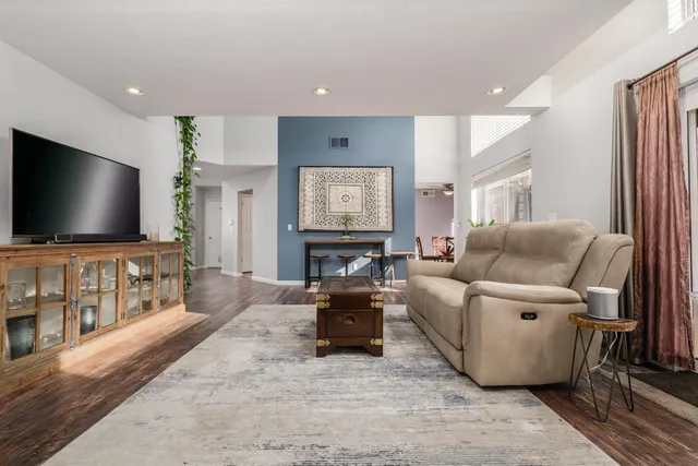 a view of a wooden deck with a small yard and wooden fence