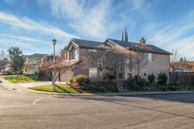 a kitchen with stainless steel appliances granite countertop a refrigerator sink and white cabinets