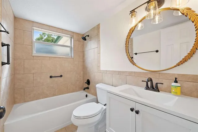 a bathroom with a sink mirror toilet and bathtub