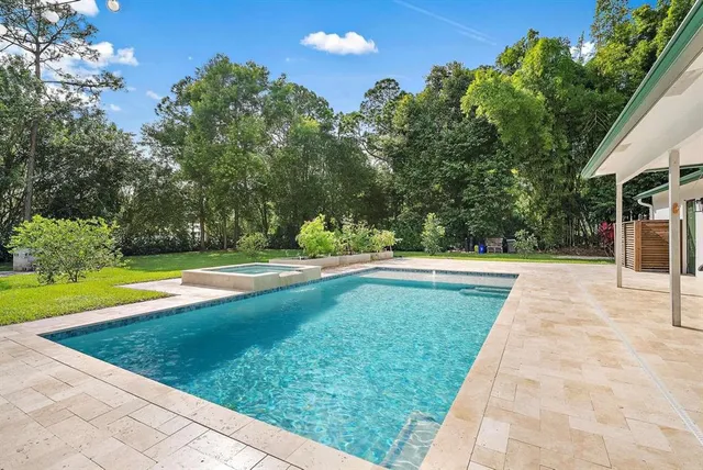 a view of swimming pool with a yard