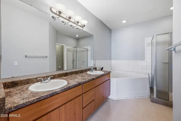 a bathroom with a granite countertop sink mirror and shower