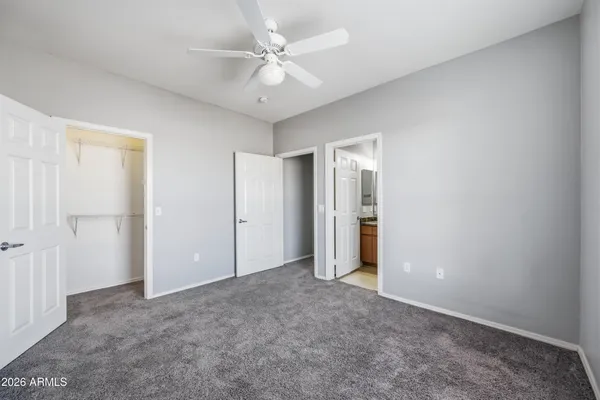 a view of an empty room with a ceiling fan