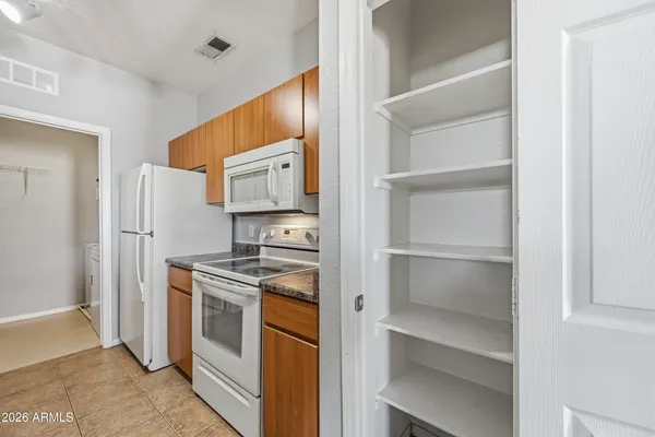 a kitchen with a stove cabinets and refrigerator