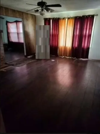 a view of a room with wooden floor and windows