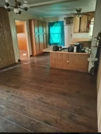 a view of a kitchen with a sink and a window