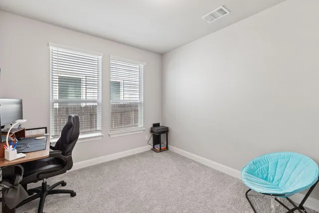 a open kitchen with stainless steel appliances kitchen island granite countertop a refrigerator a stove a sink dishwasher and white cabinets with wooden floor