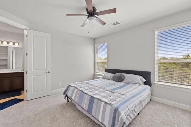 a bedroom with a bed and window