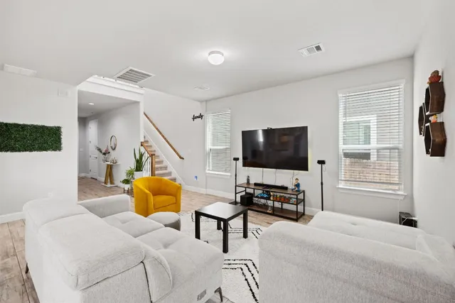 a bedroom with furniture and a flat screen tv