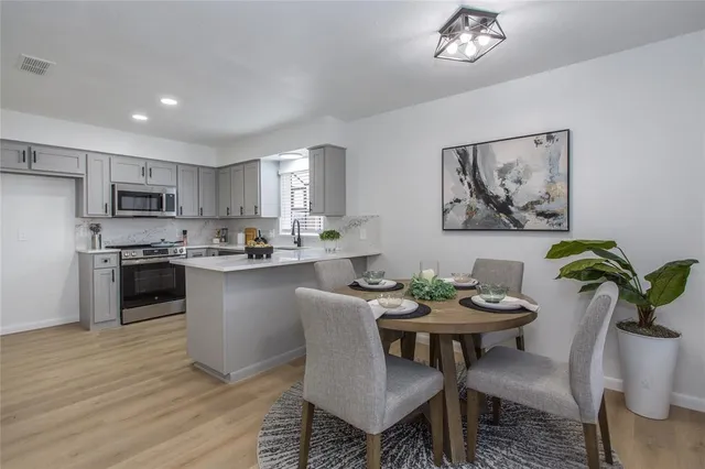 a kitchen with a table and chairs in it