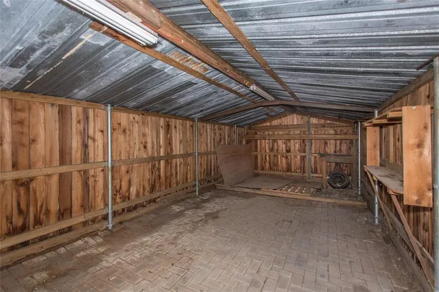 a view of an empty room with wooden walls