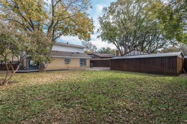 a view of a backyard with large trees