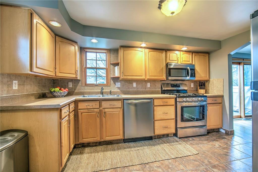 113 Leon Road Green Tree, PA 15220 - Photo 2 of 23 Spacious kitchen has plenty of counter space for food preparation and is flooded with natural light. Opens into an Eat-in-Breakfast-Bar nook and includes professional-grade stainless steel appliances, gas stove, dishwasher, recessed lighting & Home Warranty.