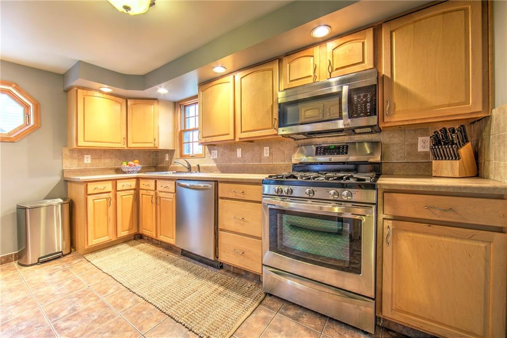 113 Leon Road Green Tree, PA 15220 - Photo 11 of 23 Spacious kitchen has plenty of counter space for food preparation and includes professional-grade stainless steel appliances, gas stove, microwave, dishwasher, recessed lighting, light fixture & Home Warranty.