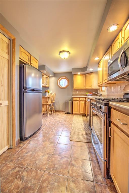 113 Leon Road Green Tree, PA 15220 - Photo 12 of 23 Kitchen with Eat-in-Breakfast-Bar nook. Conveniently access the laundry room and 1- car garage through the kitchen at the basement level.