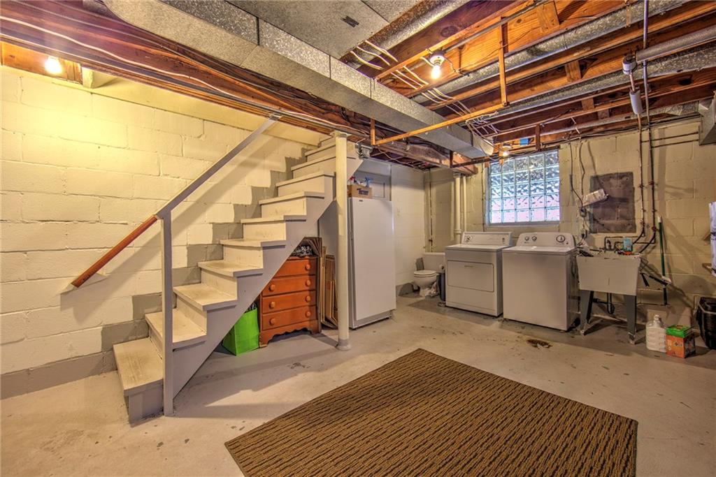 113 Leon Road Green Tree, PA 15220 - Photo 21 of 23 Laundry area in basement, which includes a separate storage room (not shown), ample room for storage and access to 1-car garage. Prime opportunity for additional livingdesign your own finished-basement or game room.