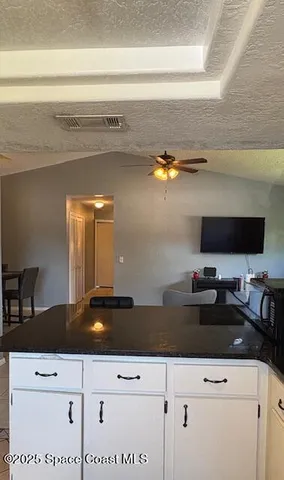 a bedroom with bed and ceiling fan