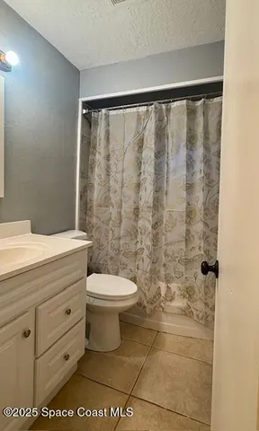a bathroom with a toilet and shower