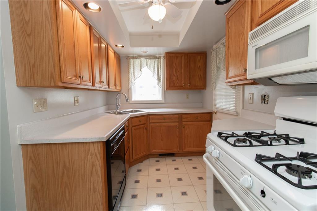 201 Kleber Road Glenshaw, PA 15116 - Photo 11 of 39 a kitchen with a sink a stove cabinets and a window