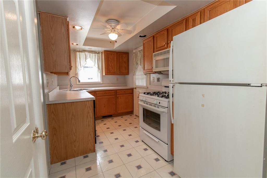 201 Kleber Road Glenshaw, PA 15116 - Photo 13 of 39 a kitchen with stainless steel appliances a sink a stove a refrigerator and cabinets