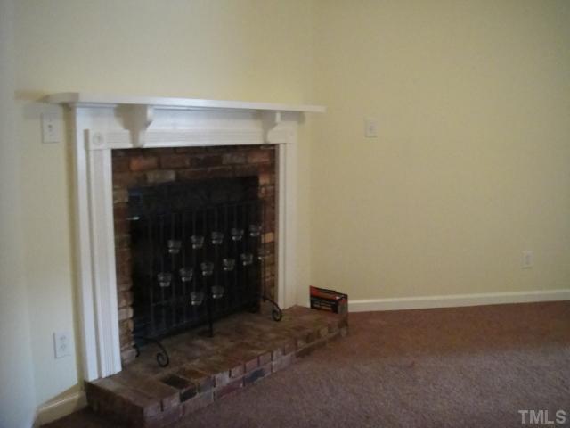 134 Towne View Trail Garner, NC 27529 - Photo 4 of 16 Corner wood burning fireplace with like new carpet & ceiling fan.