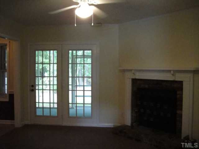 134 Towne View Trail Garner, NC 27529 - Photo 5 of 16 Another view of living room showing french doors leading onto spacious screen porch and lots of trees in backyard.
