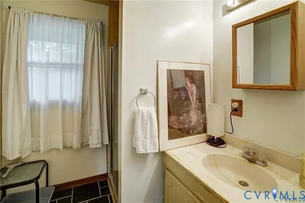 a bathroom with a sink a mirror and a shower