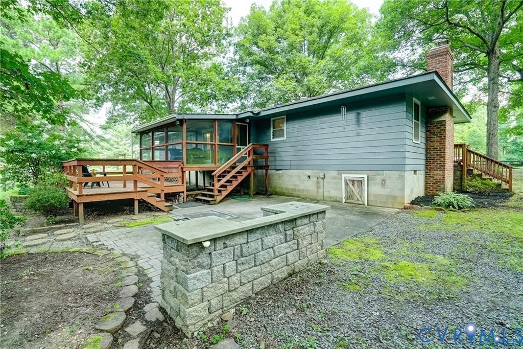 14357 Western Riders Lane Glen Allen, VA 23059 - Photo 15 of 21 a backyard of a house with wooden deck and barbeque oven