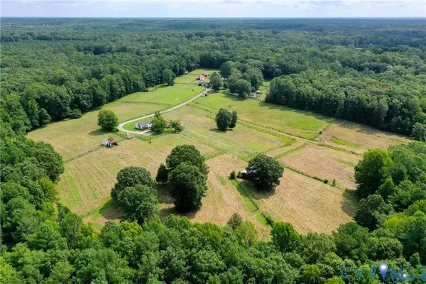 an aerial view of a house with yard and outdoor seating