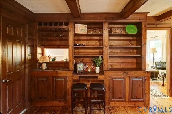 a view of a two chairs room with wooden floor and windows