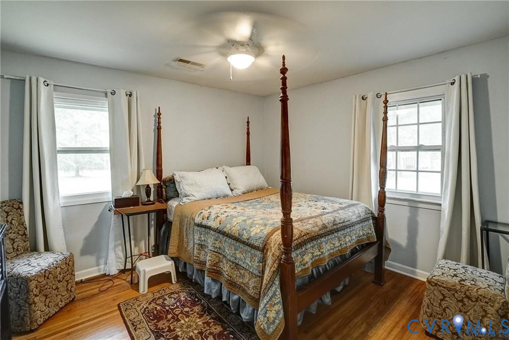 14357 Western Riders Lane Glen Allen, VA 23059 - Photo 8 of 21 a bedroom with a bed and large windows