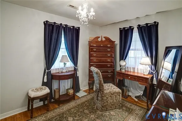 a living room with furniture a piano and a window