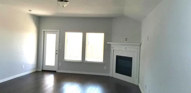 a kitchen with a sink a chandelier and wooden floor