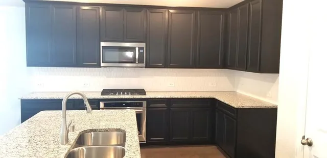a view of kitchen with microwave and cabinets