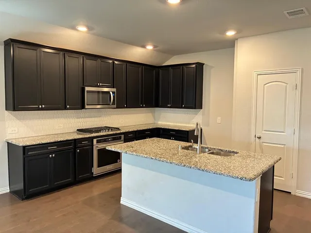 a kitchen with a sink and a microwave
